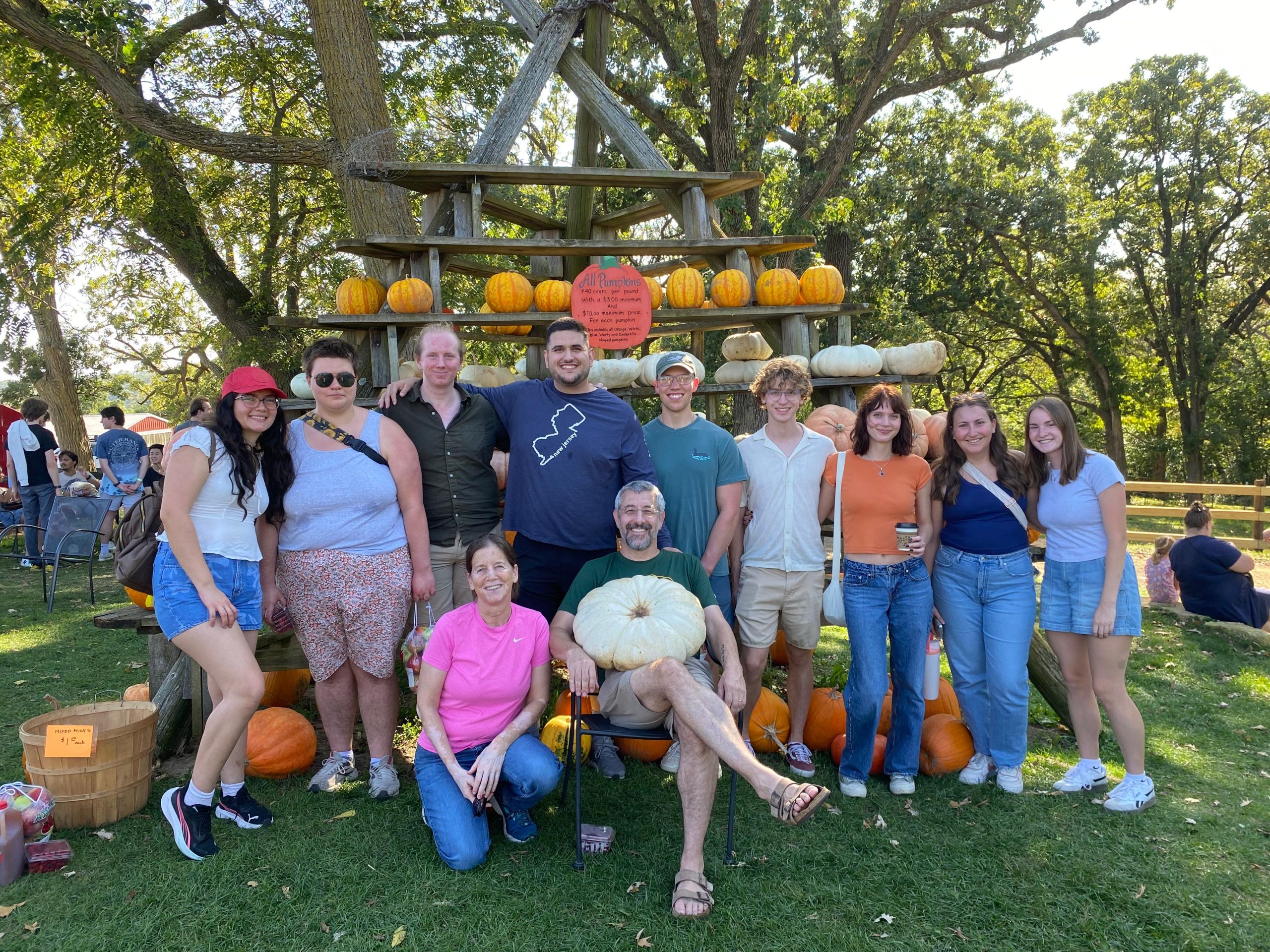 The Blum lab and family members standing for a photo while Barak sits with a very large pumpkin on his lap, out at Sutter's Ridge Farm on September 27th, 2025.