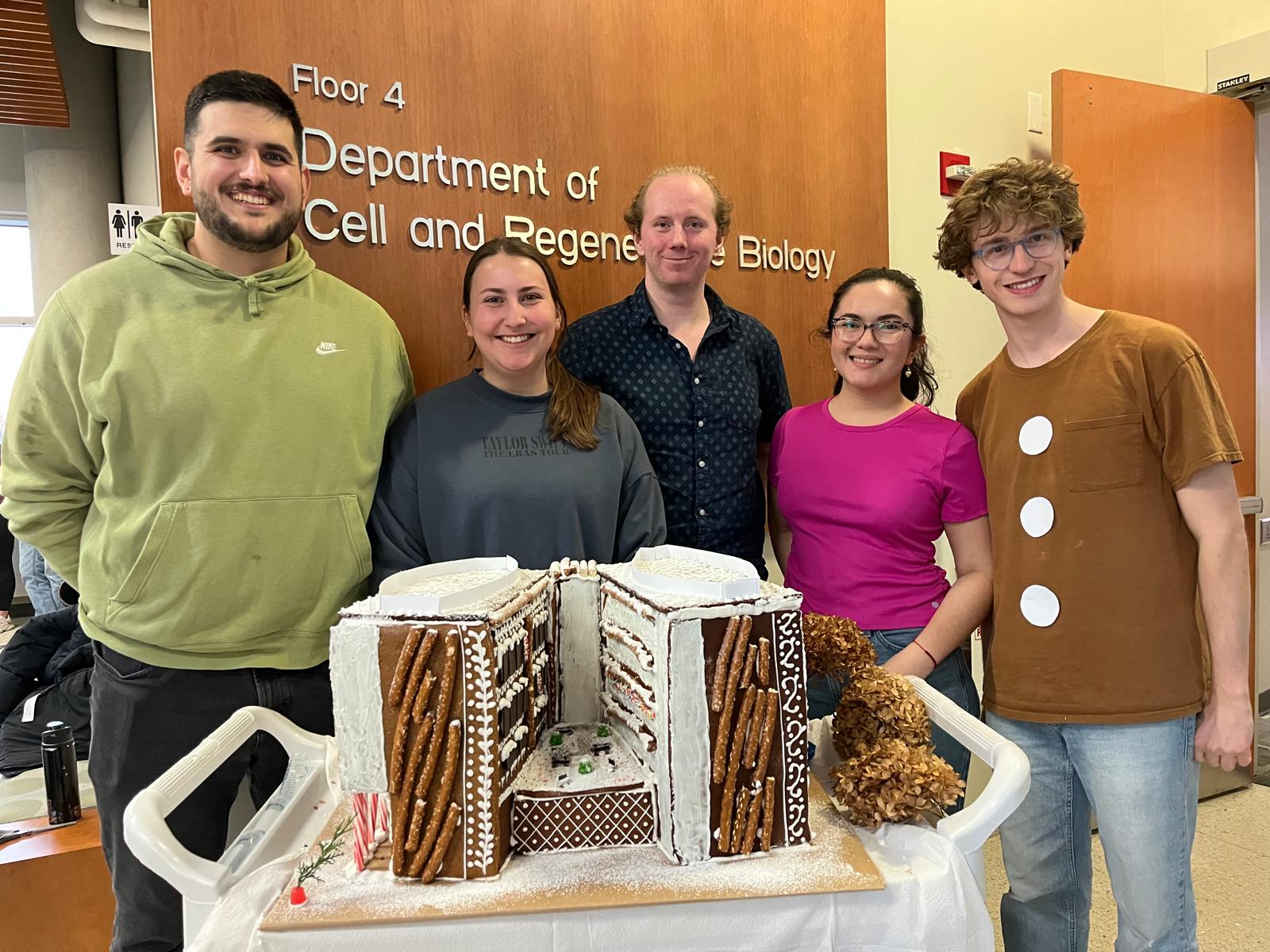 Cyrus, Rachel, Matthew, Mary, and Nicolas at the annual gingerbread house competition in December 2025